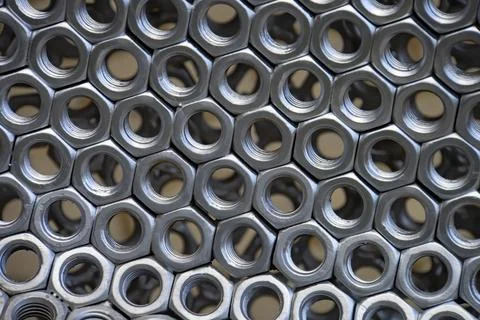 Metal nuts in a row background Stock Photos