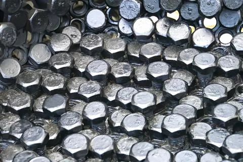 Metal nuts in a row background Stock Photos
