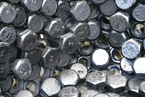 Metal nuts in a row background Foto stock
