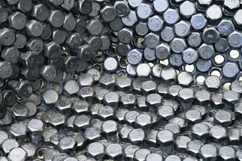 Metal nuts in a row background Stock Photos