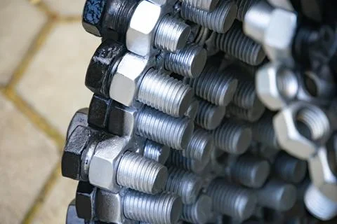 Metal nuts in a row background Stock Photos