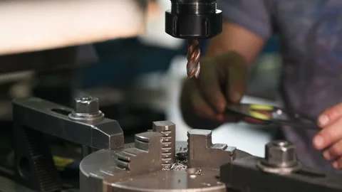 Metal part drill process work lathe engineer hands Stock Footage 136428154