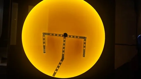 Metal pendulum elements located on a stylish yellow circle. The concept of perpe Stock Footage 283000722