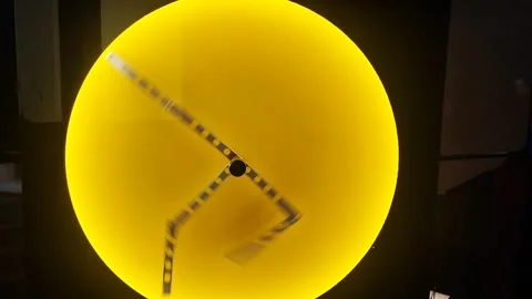 Metal pendulum elements located on a stylish yellow circle. The concept of perpe Stock Footage 283000767