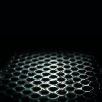 Metal perforated table surface in a dark close up Stock Photos
