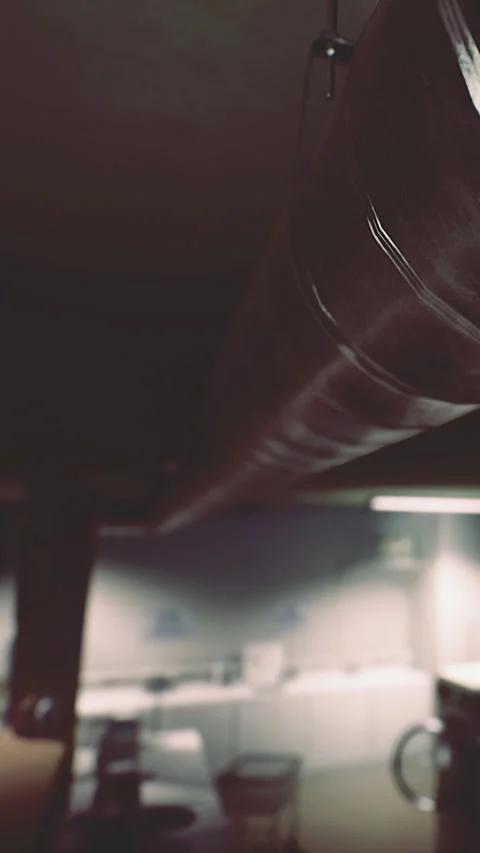 Metal pipe hangs from ceiling in a modern indoor space with soft lighting Stock Footage 330342679
