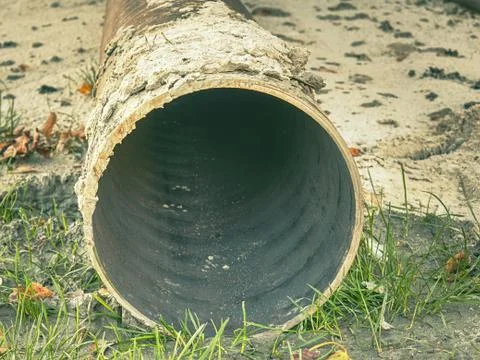 Metal pipe stack on soil. Rounded iron pipe shape ready for use. Stock Photos