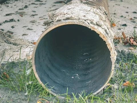 Metal pipe stack on soil. Rounded iron pipe shape ready for use. Stock Photos