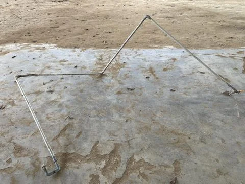 Metal Pipe Structure On Rough Concrete Ground Surface Stock-Fotos