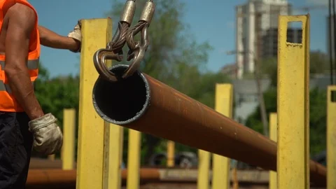 Metal pipe transported by crane under builder control Stock Footage 113395358