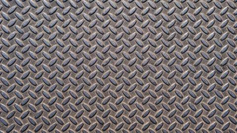 A metal plate with a seamless repeating pattern. Abstract metallic background Stock Photos