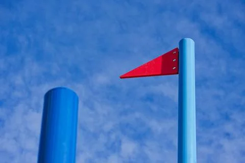 Metal pole with fixed red triangular signal flag marker Stock Photos