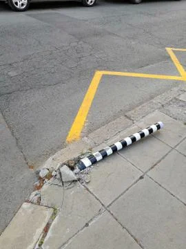 A metal pole is lying at the intersection, as a result of an accident. Stock Photos