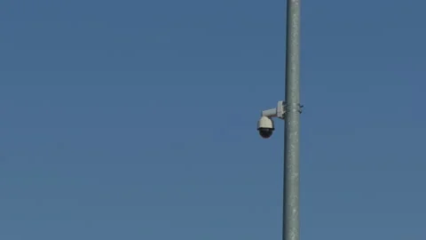 Metal pole mounted camera in daylight setting. Public surveillance equipment Stock Footage 332874334