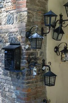 Metal post box and lanterns in vintage style on the wall. Grazzano Visconti,  Stock Photos