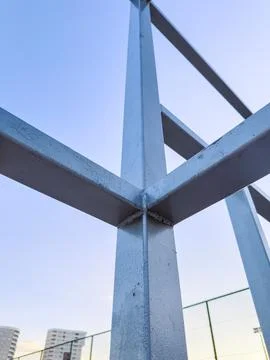 Metal posts are arranged in a vertical and horizontal pattern with a clear bl Stock Photos