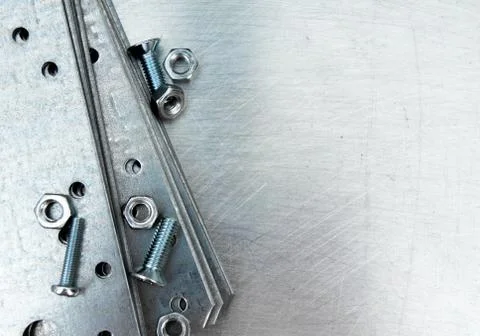 Metal preparations and fixing elements on the scratched metal background. Stock Photos