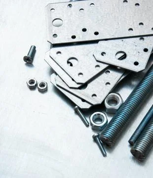 Metal preparations and fixing elements on the scratched metal background. 스톡 사진