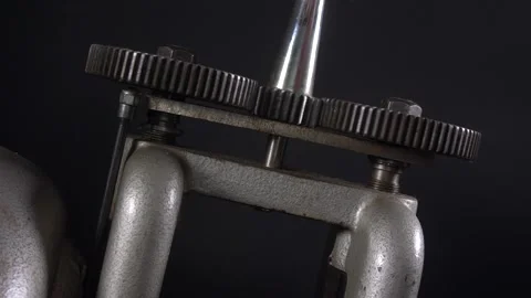 Metal press on a dark background, cogs turning Stock Footage