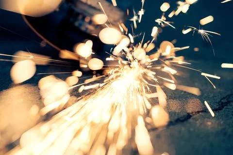 Metal processing with an angle grinder. sparks fly from hot metal Stock Photos