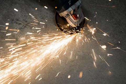 Metal processing with an angle grinder. sparks fly from hot metal Stock Photos