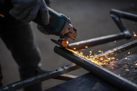 Metal processing in the workshop. Grinding metal. Stock Photos