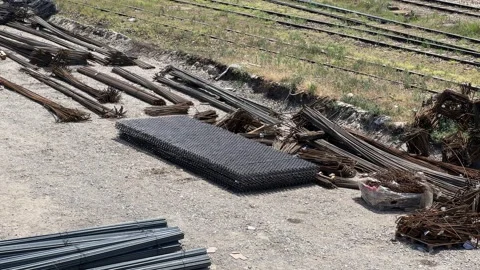 Metal products and structures lie on the construction site Stock Footage 246388034