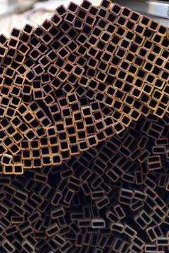 Metal profile pipe of rectangular cross section in packs at the warehouse of Stock-Fotos