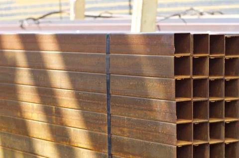Metal profile pipe of rectangular cross section in packs at the warehouse of 库存照片