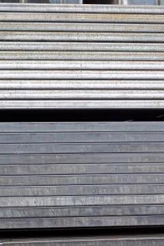 Metal profile pipe of rectangular cross section in packs at the warehouse of Photos