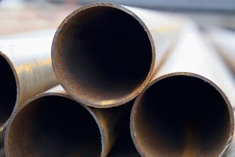 Metal profile pipe of round section in packs at the warehouse of metal produc 写真素材