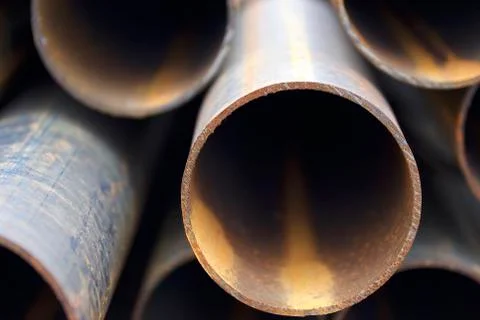 Metal profile pipe of round section in packs at the warehouse of metal produc 写真素材