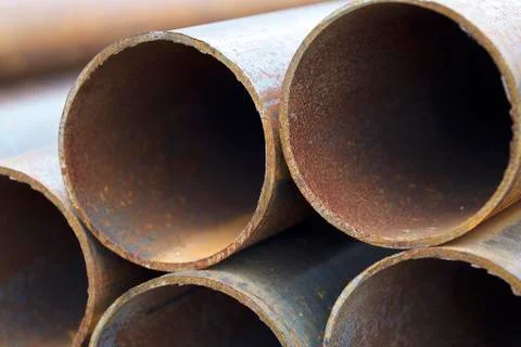 Metal profile pipe of round section in packs at the warehouse of metal produc Foto stock