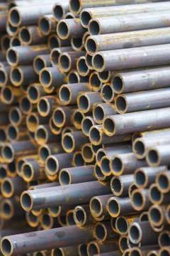 Metal profile pipe of round section in packs at the warehouse of metal produc 写真素材