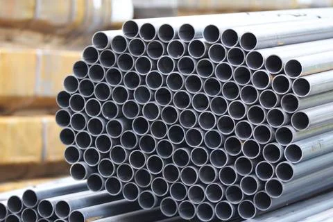 Metal profile pipe of round section in packs at the warehouse of metal produc Stockfoto's