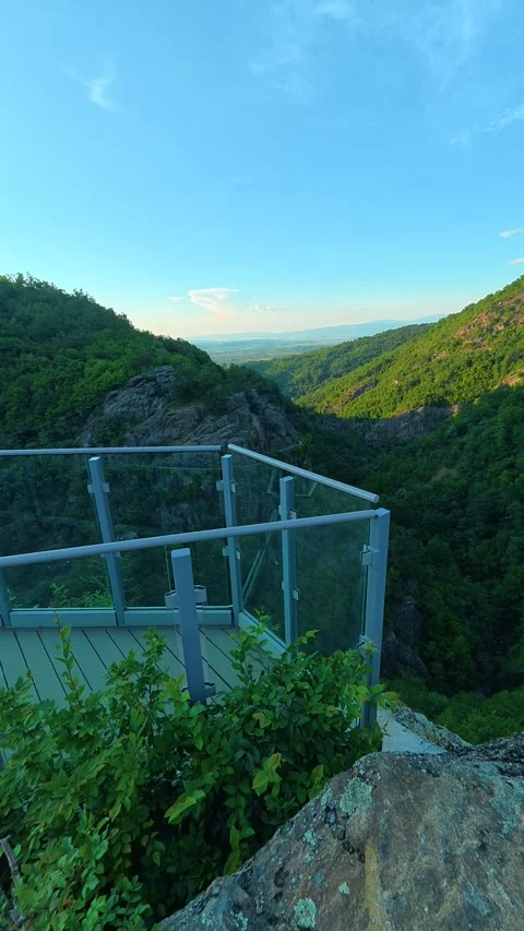 Metal railing frames a lush green valley. Sokolica rock, Serbia. Vertical Stock Footage 341132615