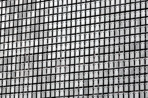 Metal rectangular plates with screws and rivets on the facade. Stock Photos