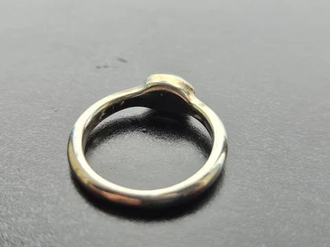 Metal Ring on Dark Textured Surface Stock Photos
