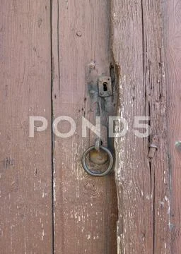Metal ring on an old wooden door Stock Photos