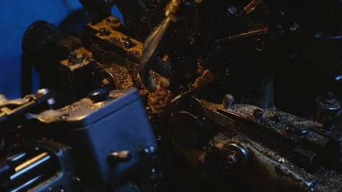 The metal rod is a workpiece that exits the machine in the workshop. Stock Footage 116077099