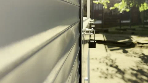 Metal Roller Shutter Locks Securely Over Outdoor Kiosk Window Stock Footage 336935237