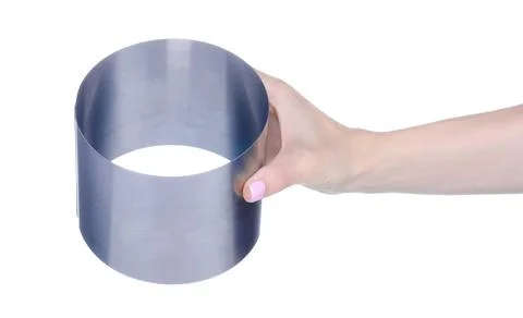 Metal round dish for baking cake in hand Stock Photos