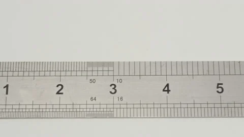 Metal ruler on white background. Sliding in front of metal ruler with scales to Stock Footage 202066664