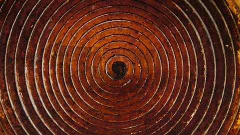 Metal rusty surface of frying pan with spiral round pattern. Rotation Stock Footage 247437847