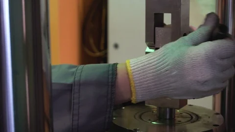 Metal sample is tested for compressive strength. Footage. Close-up of metal Stock Footage 97501445