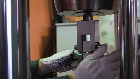 Metal sample is tested for compressive strength. Footage. Close-up of metal Stock Footage 97501479