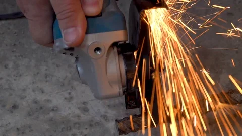 A metal saw with a disc grinder in a workshop. Sparks fly out of the circle Stock Footage 115439484