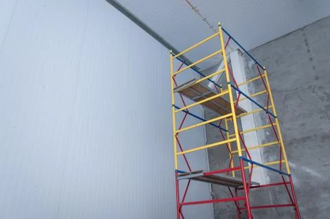 Metal scaffolding in a building under construction. Stock Photos