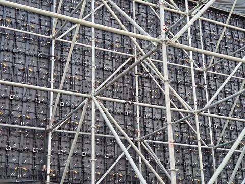 Metal scaffolding framework supporting a large LED video wall panel array Stock Photos