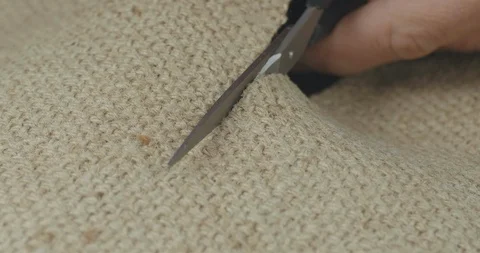 Metal scissors in the hands of the master cut the burlap fabric. hand tool Stock Footage 121536371